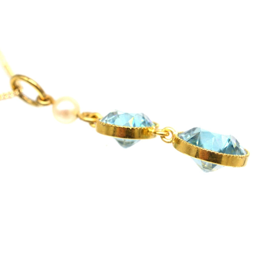 Edwardian 18ct gold pendant featuring two blue zircons and a natural pearl on a 9ct gold chain.