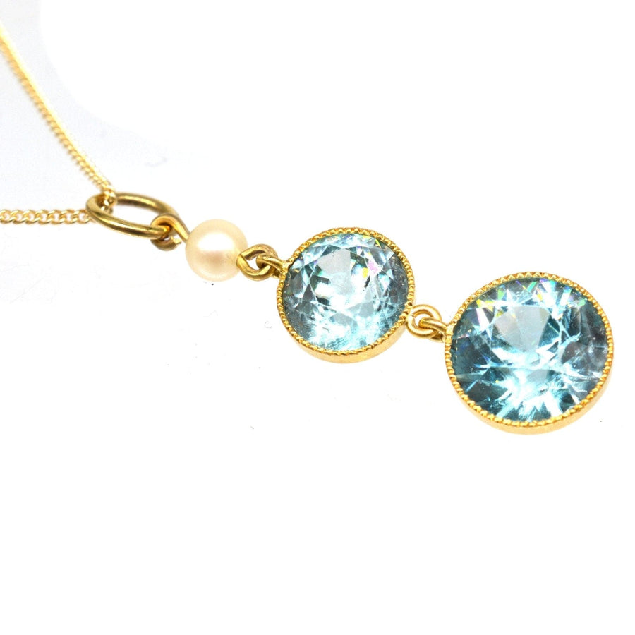 Edwardian 18ct gold pendant featuring blue zircon drops and a pearl, on a 9ct gold chain.