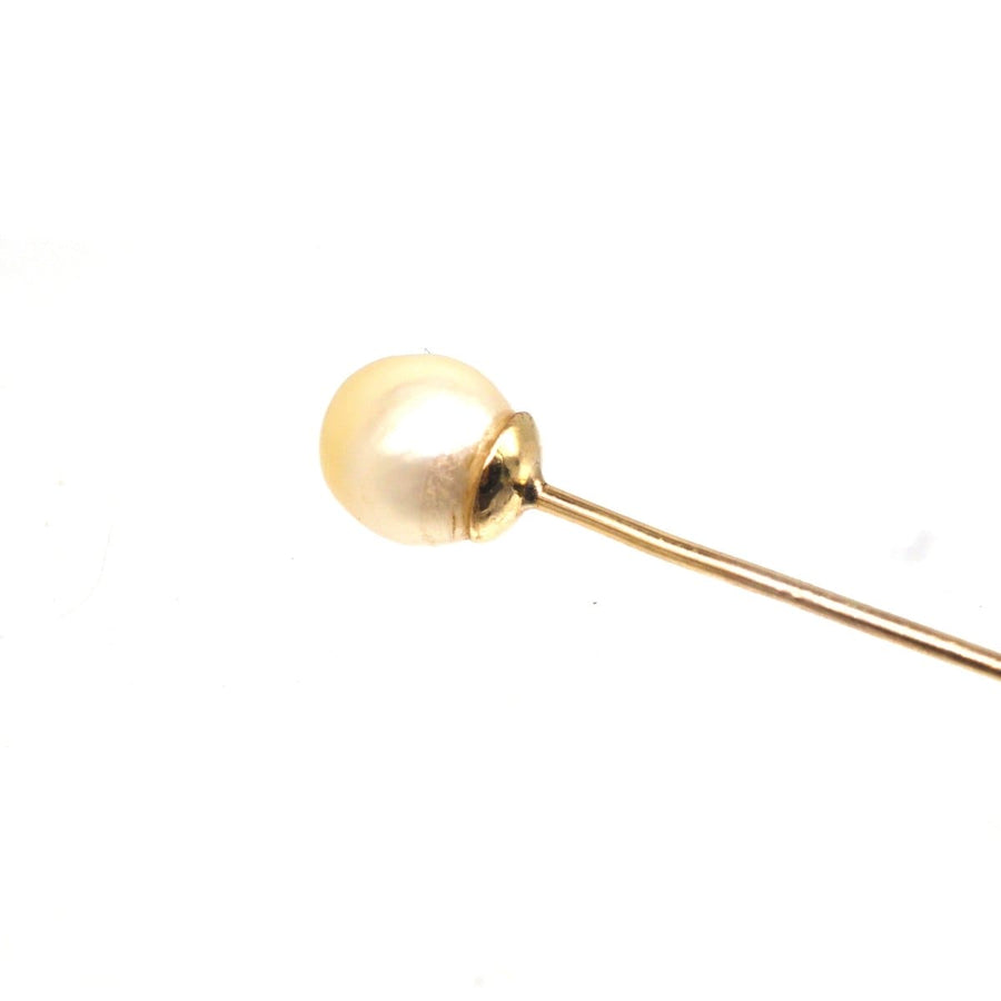 Close-up of an Edwardian 18ct gold tie pin featuring a natural saltwater pearl, showcasing its vintage elegance.