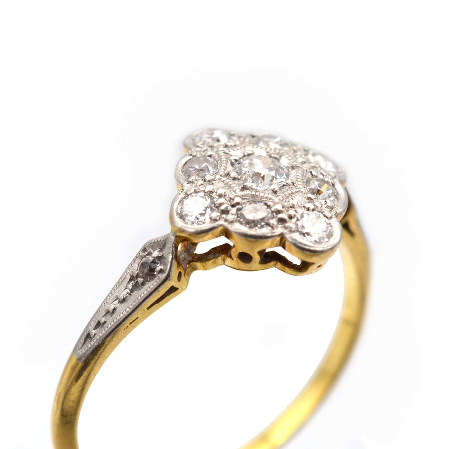Edwardian 18ct gold and platinum diamond cluster ring with elegant design and bright, white diamonds.