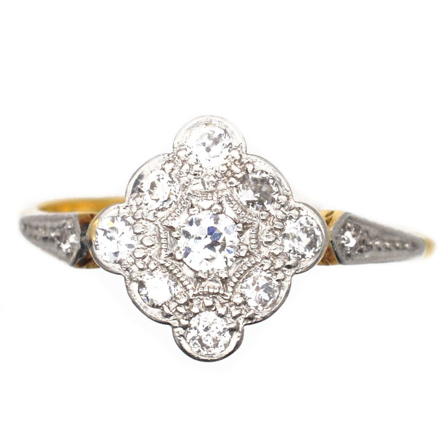 Edwardian 18ct gold and platinum diamond cluster ring with intricate design and low profile for comfortable wear.