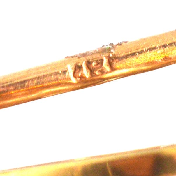 Close-up of the hallmark on an Edwardian 18ct gold pin showcasing craftsmanship and authenticity.