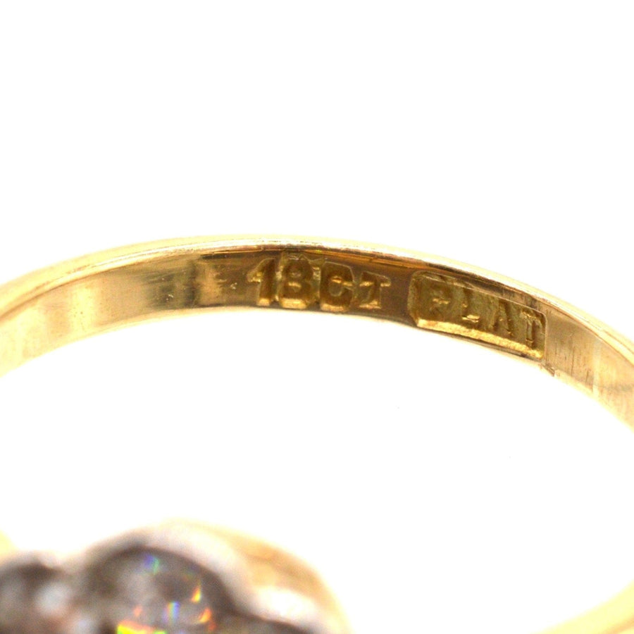 Close-up of hallmarked inside of Edwardian 18ct gold and platinum ruby diamond cluster ring.