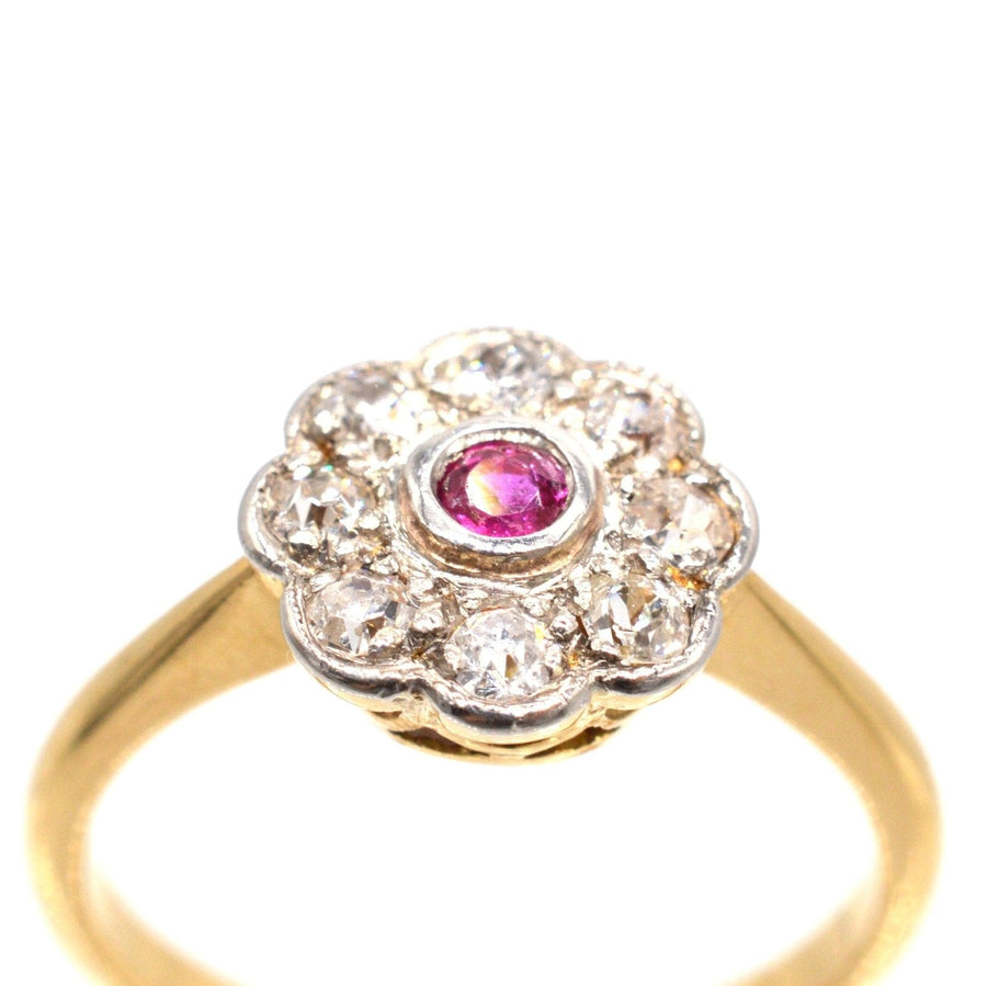 Edwardian 18ct gold and platinum ruby diamond cluster ring, featuring a central ruby surrounded by sparkling diamonds.
