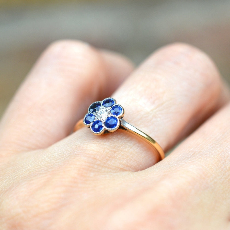 Edwardian 18ct gold and platinum flower cluster ring featuring sapphires and diamonds.
