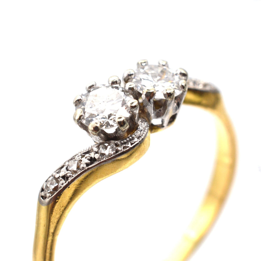 Edwardian gold and platinum two stone diamond 'Toi et Moi' crossover ring with 0.20 carat diamonds.