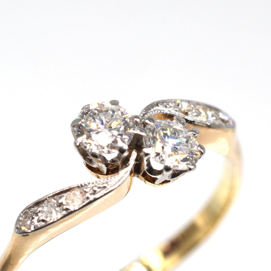 Edwardian 18ct gold and platinum 'Toi et Moi' crossover ring with two dazzling diamonds.