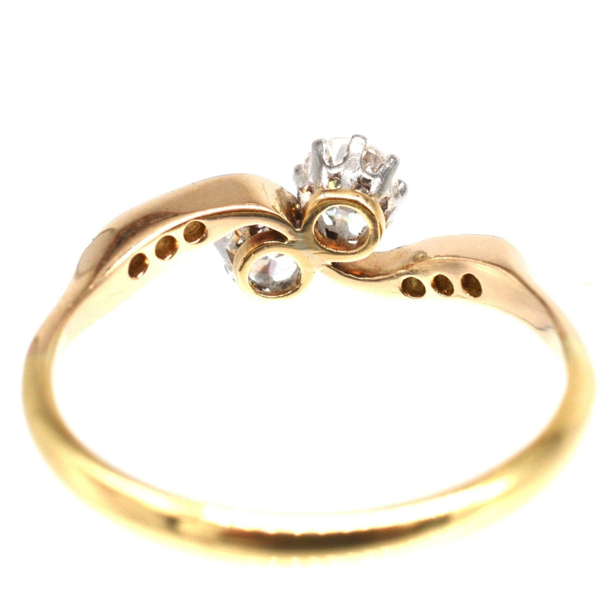 Edwardian 18ct gold and platinum two stone diamond 'Toi et Moi' crossover ring, symbolizing love and romance.