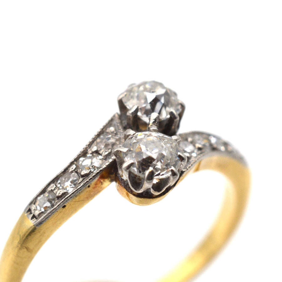 Edwardian 18ct gold and platinum two stone diamond 'Toi et Moi' crossover ring with elegant design.