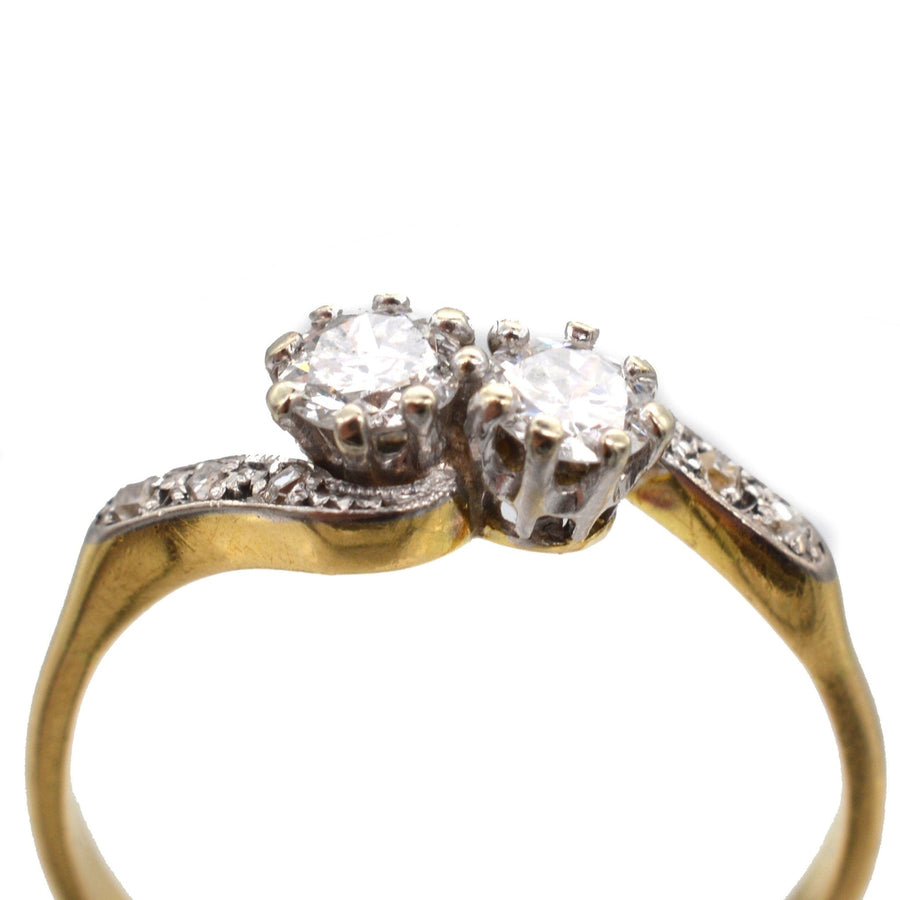 Edwardian 18ct gold and platinum two stone diamond crossover ring with bright white diamonds.