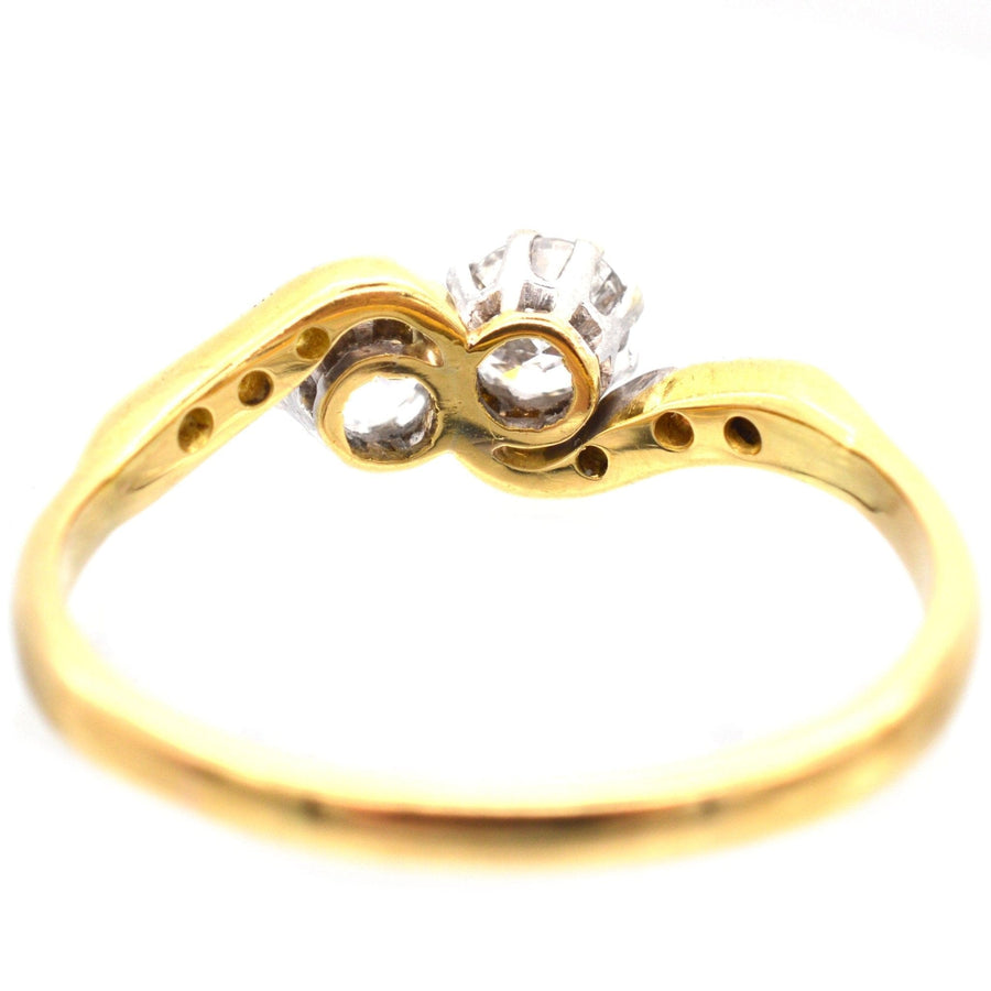 Edwardian two stone diamond 'Toi et Moi' crossover ring in 18ct gold and platinum.