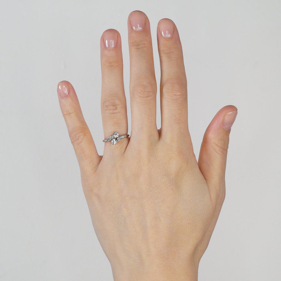 Elegant Edwardian 18ct gold and platinum diamond 'Toi et Moi' crossover ring on hand.
