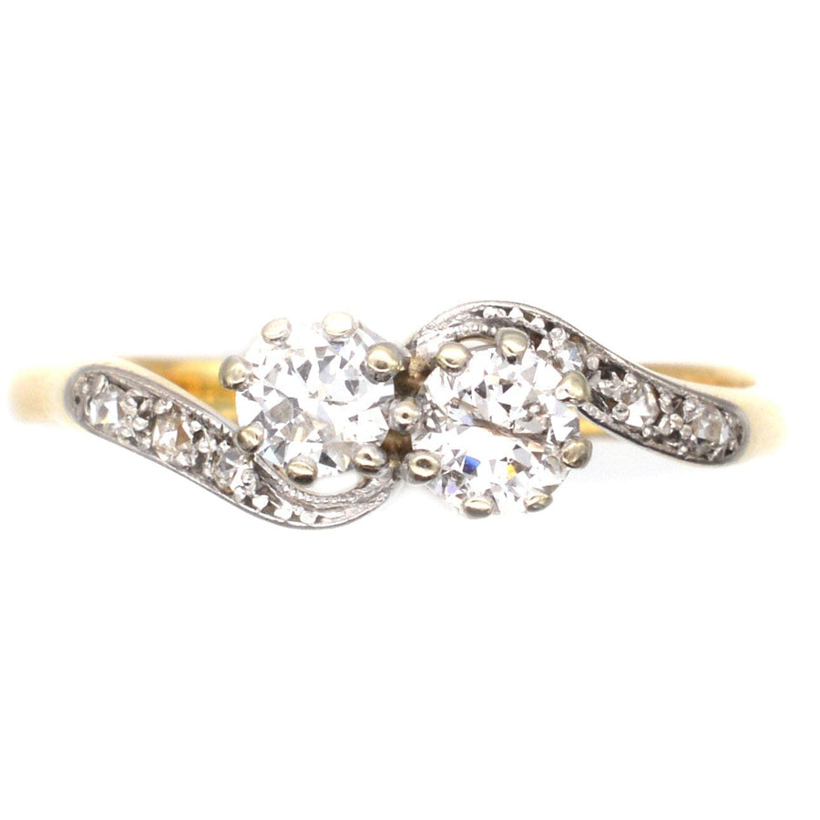 18ct gold and platinum Toi et Moi crossover ring with two diamond stones, symbolizing love and unity.