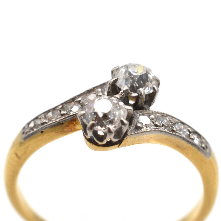 Edwardian 18ct gold and platinum two stone diamond 'Toi et Moi' crossover ring with 0.25 carat diamonds.