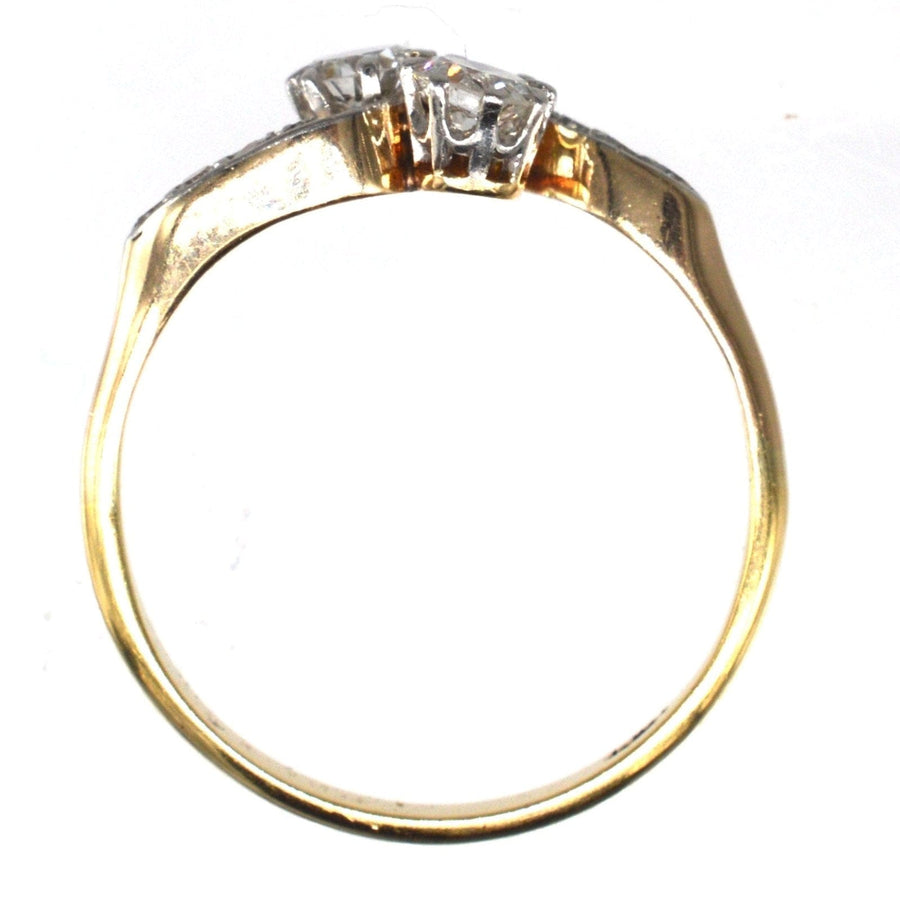 Edwardian 18ct gold and platinum crossover ring featuring two sparkling diamonds, symbolizing 'Toi et Moi' love.