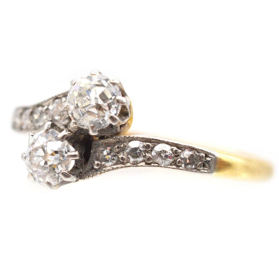 Edwardian 18ct gold and platinum two stone diamond 'Toi et Moi' crossover ring with bright diamonds.