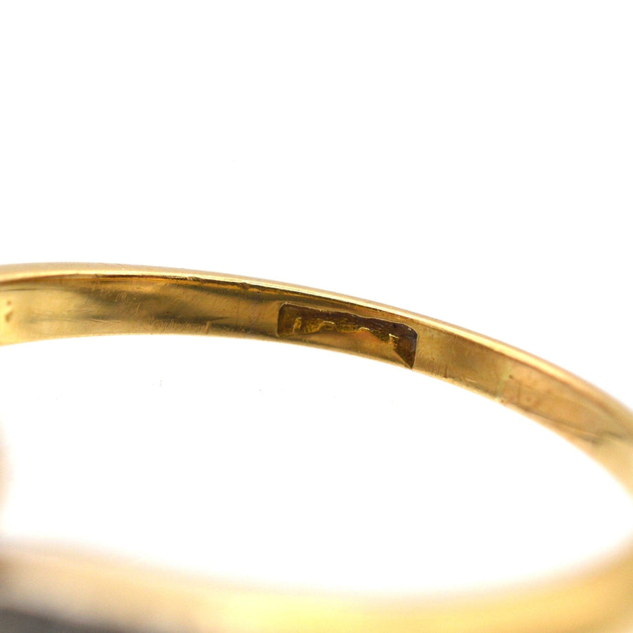Close-up of the inner band showing the hallmark of an Edwardian gold and platinum crossover ring.