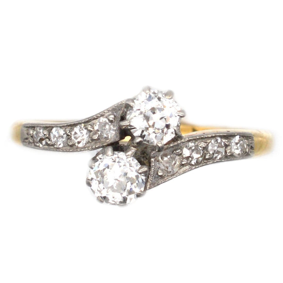 Edwardian 18ct gold and platinum crossover ring with two diamond stones, featuring a romantic 'Toi et Moi' design.