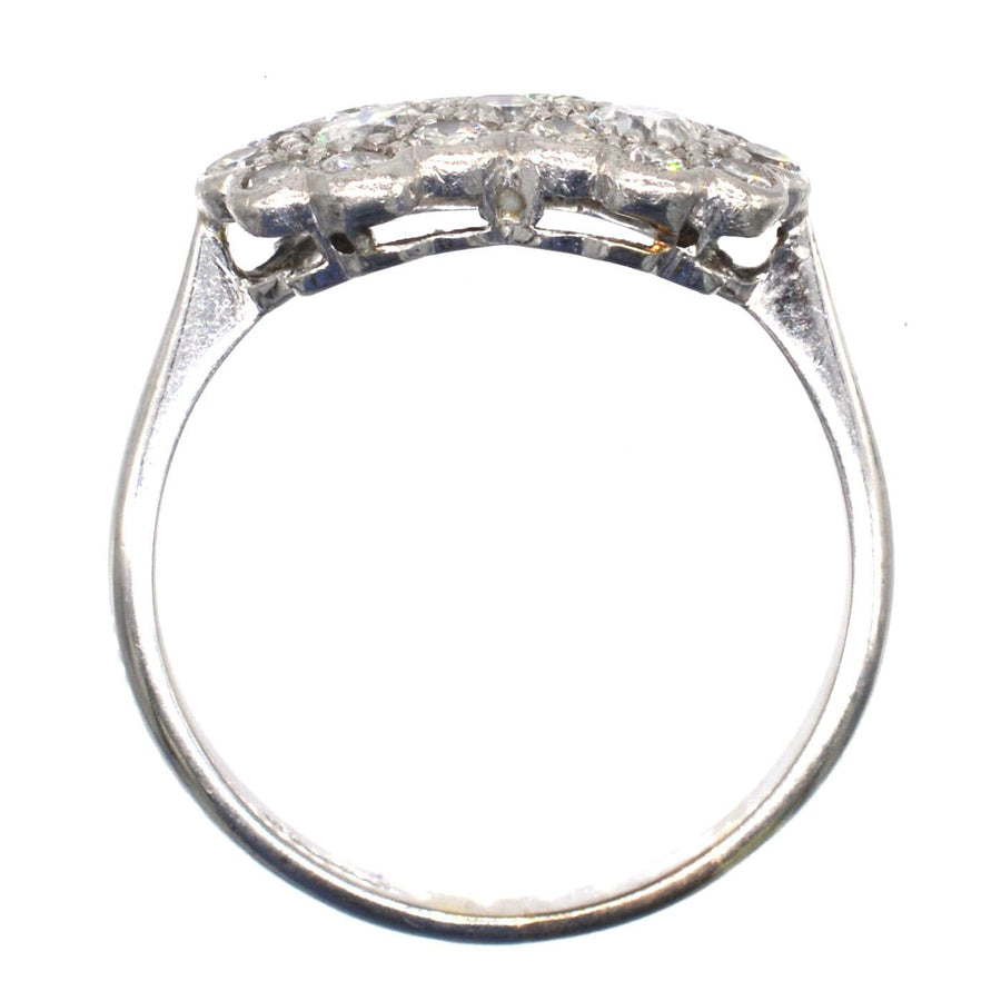Edwardian 18ct white gold and platinum double cluster diamond ring showcasing its intricate design and brilliant stones.