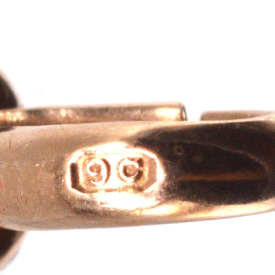 Close-up of Edwardian 9ct Gold Albert Dog Clip showing hallmark with '9C' stamp for authenticity.