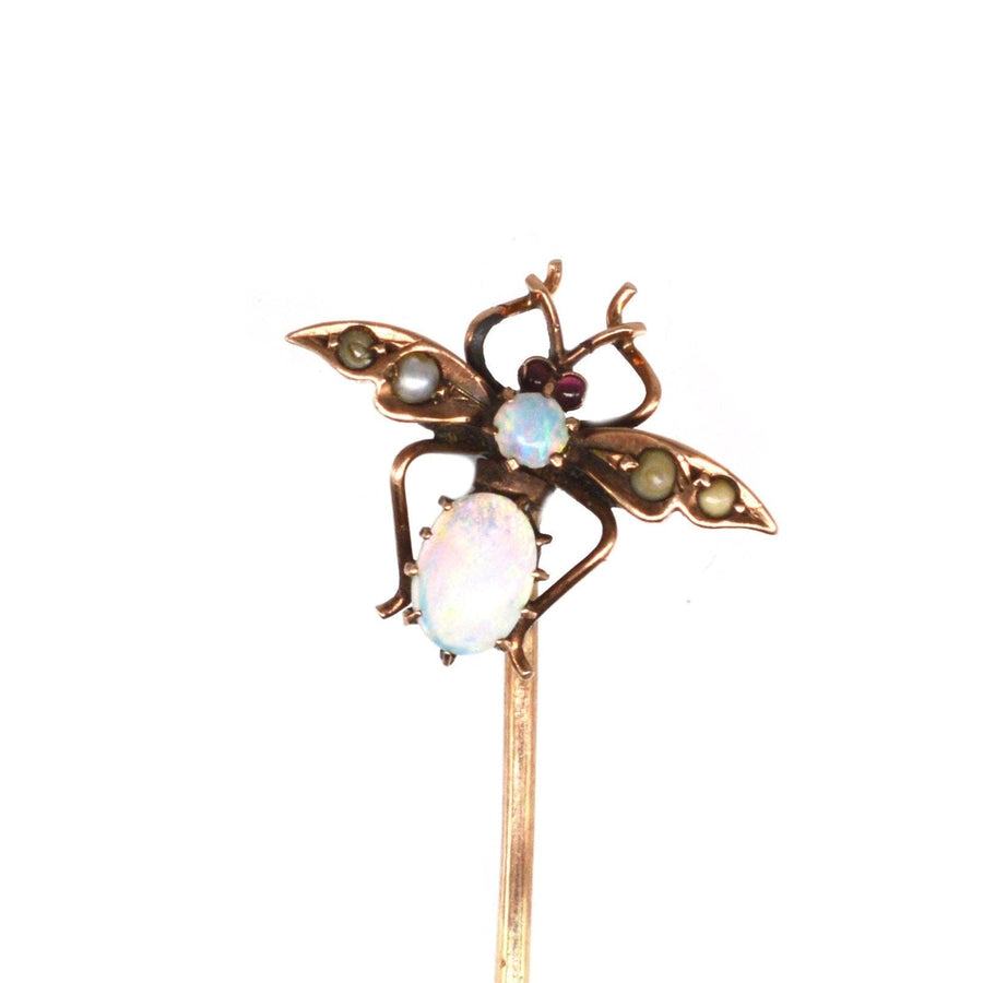 Edwardian 9ct gold bee tie pin featuring opal, seed pearls, and garnet eyes, ideal for lapel or tie.