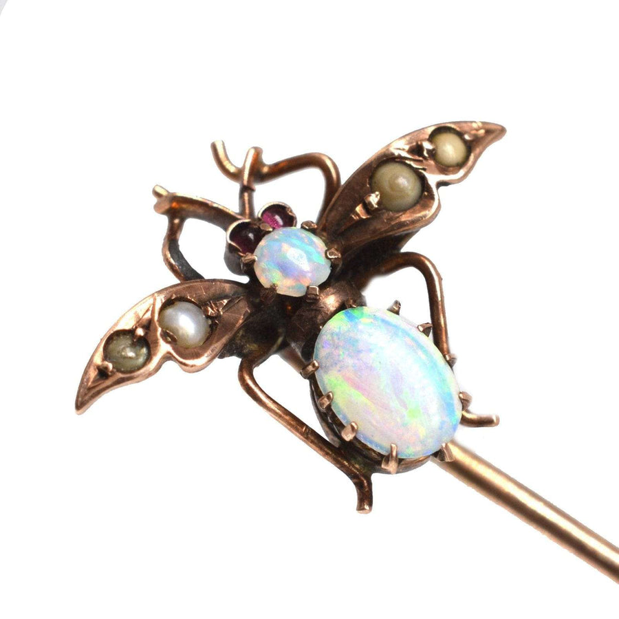 Edwardian 9ct gold bee tie pin featuring opal, seed pearls, and garnet eyes, ideal for lapels or ties.