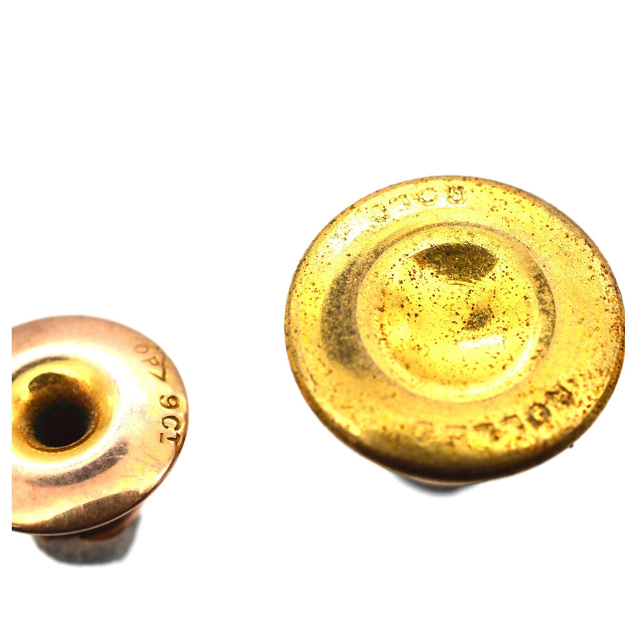 Close-up of vintage brass grommets showcasing intricate design and aged patina, perfect for crafts or decoration.