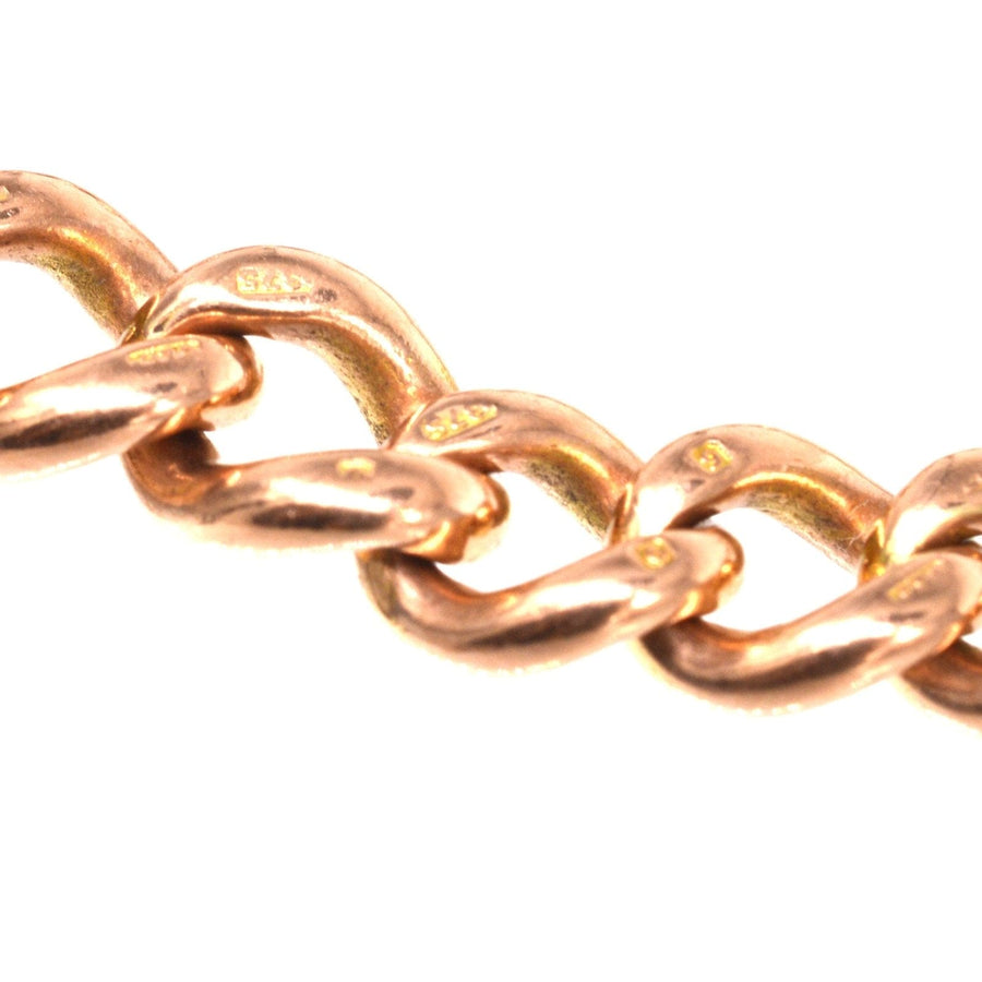 Close-up of Edwardian 9ct gold curb link bracelet highlighting hallmarks and intricate design.