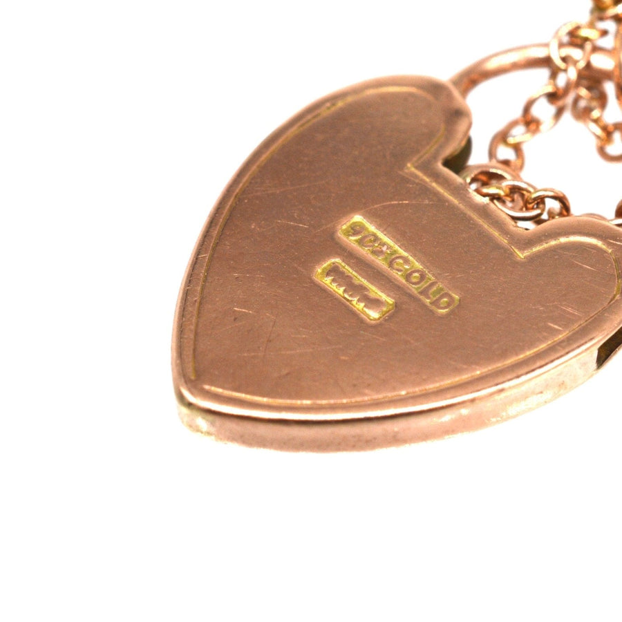 Hallmarked heart padlock of an Edwardian 9ct gold curb link bracelet, showcasing solid gold craftsmanship.