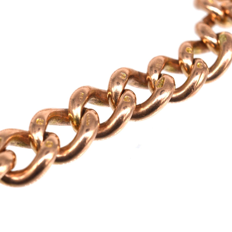 Close-up of an Edwardian 9ct gold curb link bracelet showcasing hallmarked solid gold links.