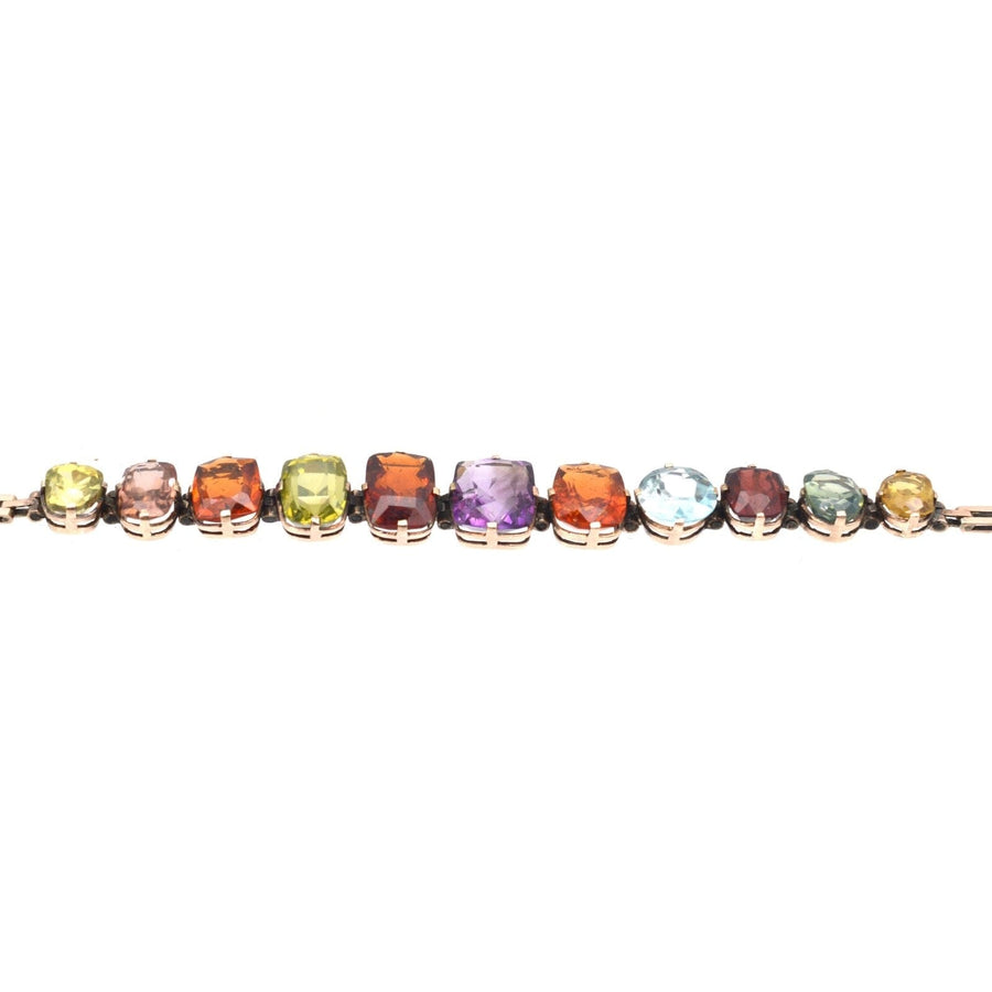 Edwardian 9ct gold harlequin multi-gem bracelet featuring citrine, garnet, aquamarine, and more vibrant gemstones.