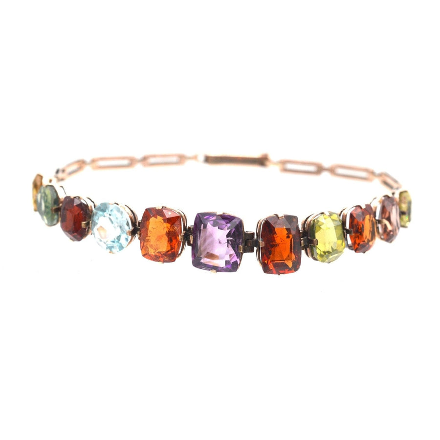 Edwardian 9ct gold harlequin multi-gem bracelet featuring citrine, tourmaline, garnet, aquamarine, and amethyst.