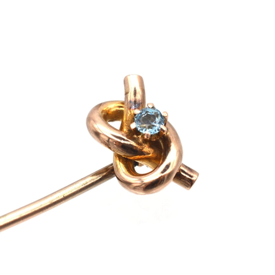 Edwardian 9ct gold lover's knot tie pin featuring aquamarine gemstone, perfect for enhancing silk ties.