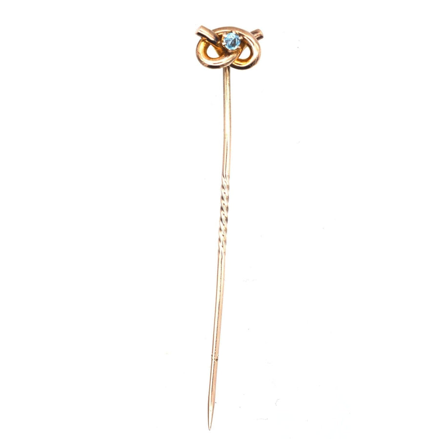 Edwardian 9ct gold lover's knot tie pin with aquamarine centerpiece, ideal for colorful silk ties.