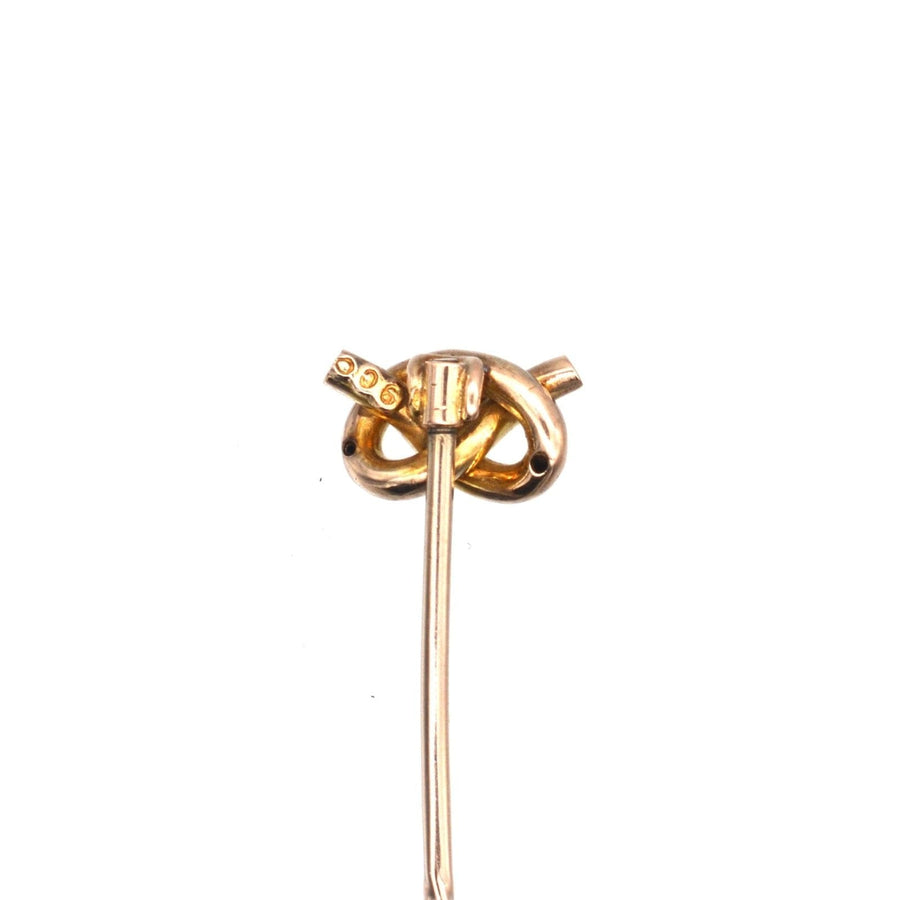 Edwardian 9ct gold lover's knot tie pin with aquamarine centerpiece, ideal for a stylish silk tie.