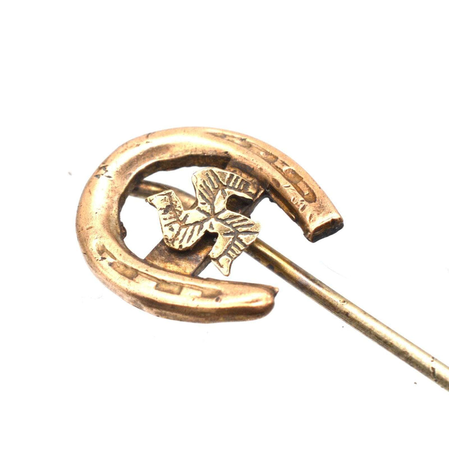 Edwardian 9ct gold horseshoe tie pin with Isle of Man Triskelion, symbolizing luck and heritage.