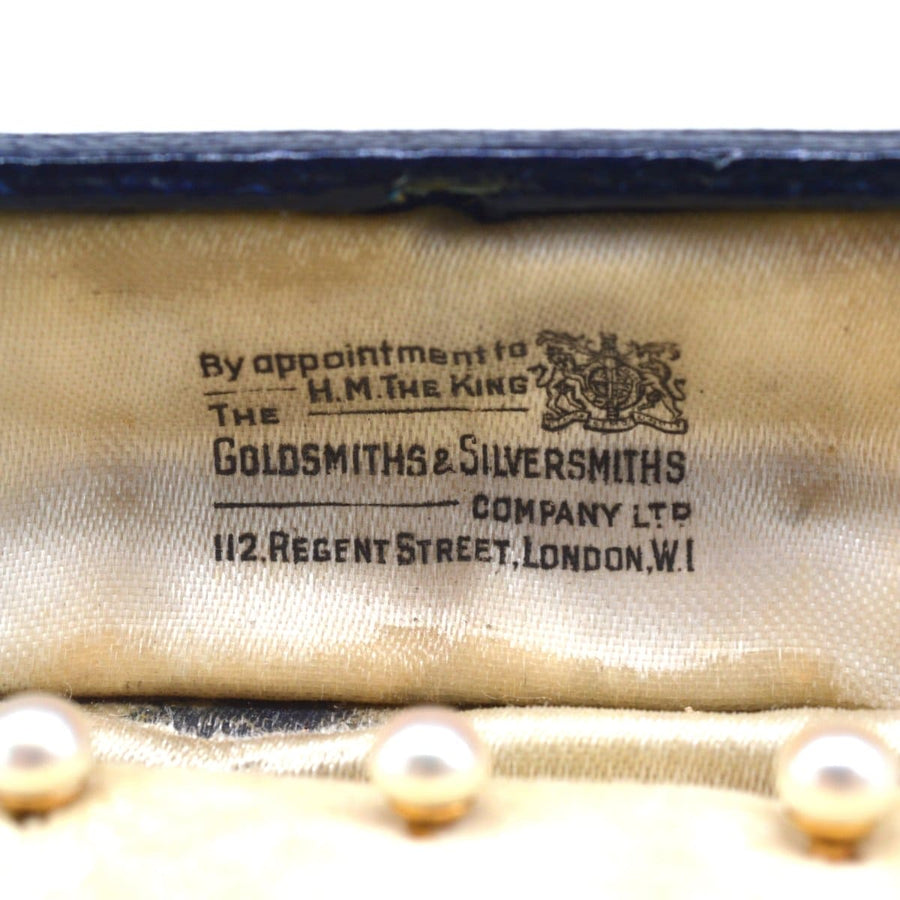 Goldsmiths & Silversmiths Company label in a vintage jewelry box, showcasing its prestigious heritage.