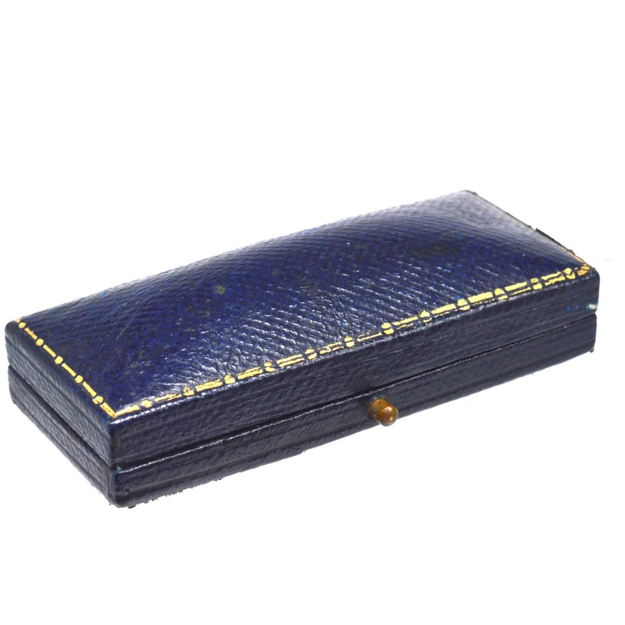Elegant navy blue vintage jewelry box with gold trim, perfect for storing dress studs and accessories.