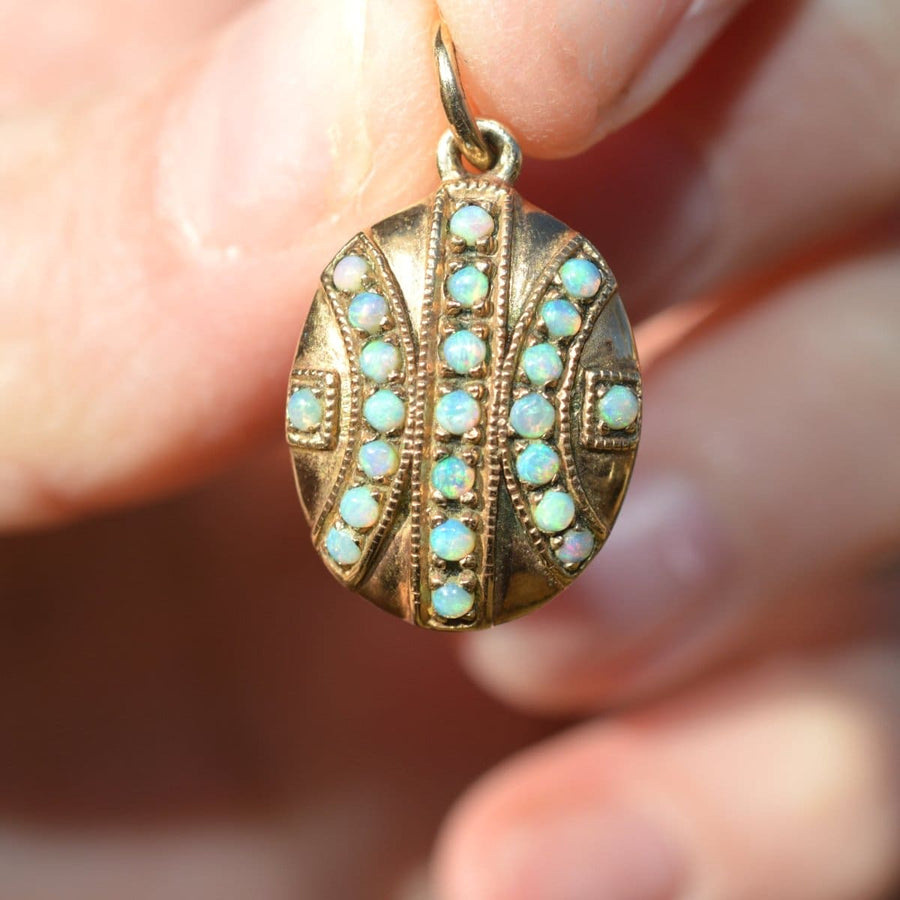 Edwardian 9ct gold pendant featuring 23 vibrant opals in a geometric design, perfect for October birthdays.