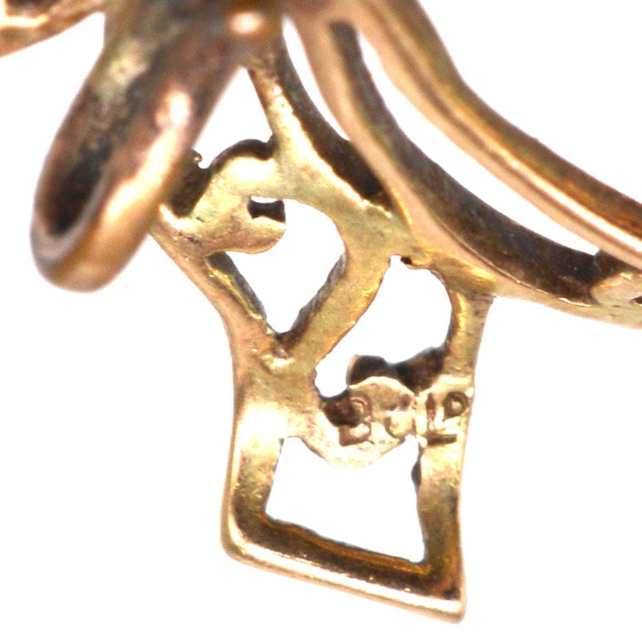 Close-up of Edwardian 9ct gold brooch showcasing intricate bow design and hook detail for versatile use.