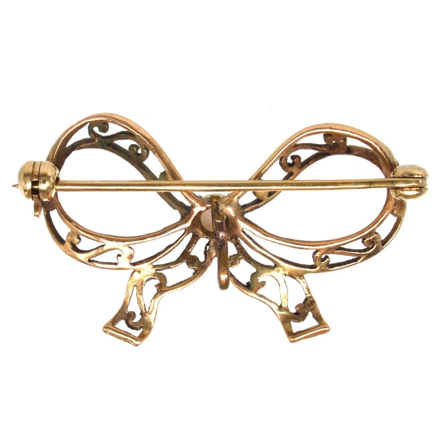 Edwardian 9ct gold bow brooch with intricate design, perfect for adding elegance to any lapel.