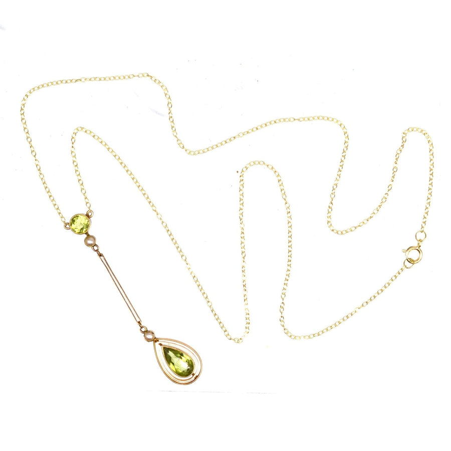 Edwardian 9ct gold drop pendant with olive green peridot on delicate chain, showcasing elegance and vintage charm.