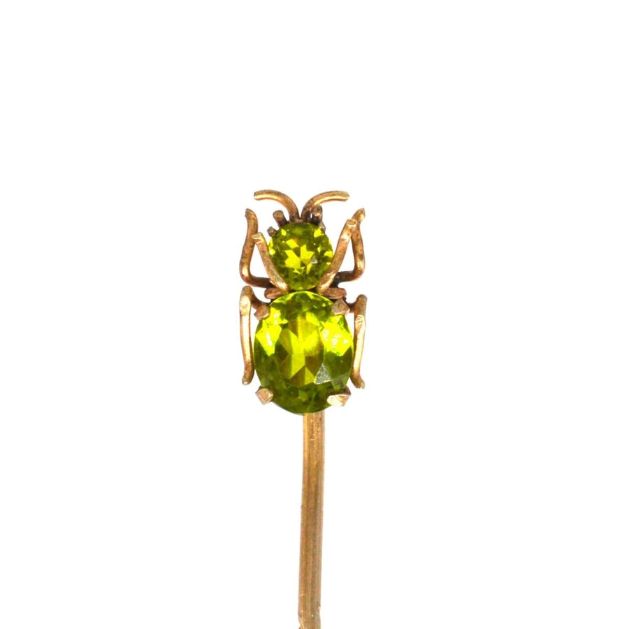 Edwardian 9ct gold bug tie pin set with vibrant green peridot, ideal gift for August birthdays.