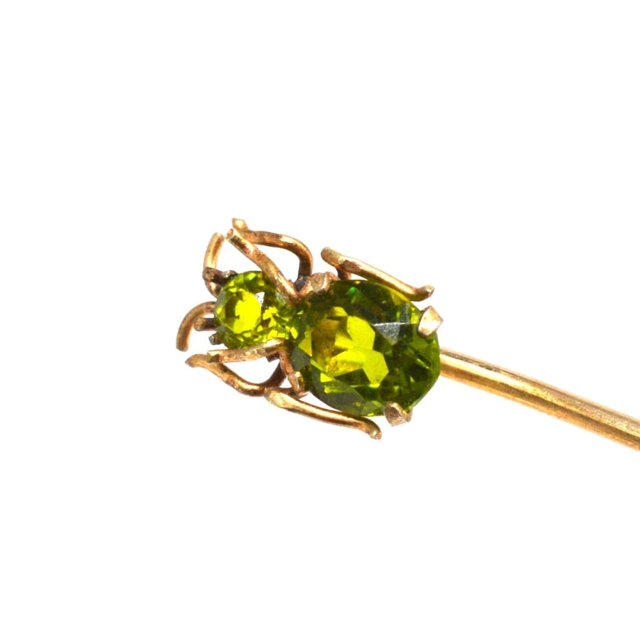 Edwardian 9ct gold bug tie pin featuring vibrant peridot gemstones, perfect for stylish silk ties.