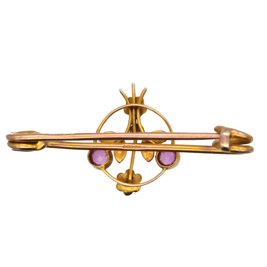 Edwardian 9ct gold brooch featuring pink sapphire flowers and pearl leaves, perfect for lapel or tie.