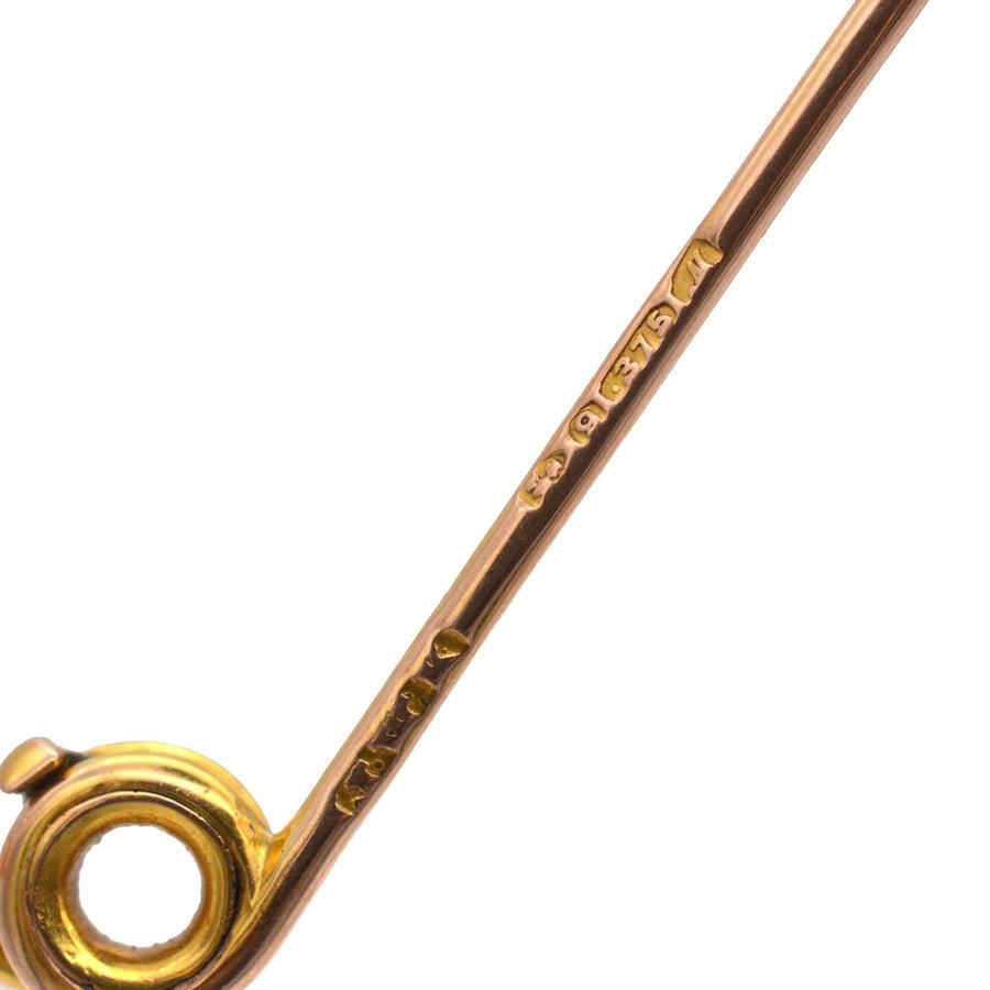 Close-up of an Edwardian gold brooch featuring intricate craftsmanship and maker's mark.