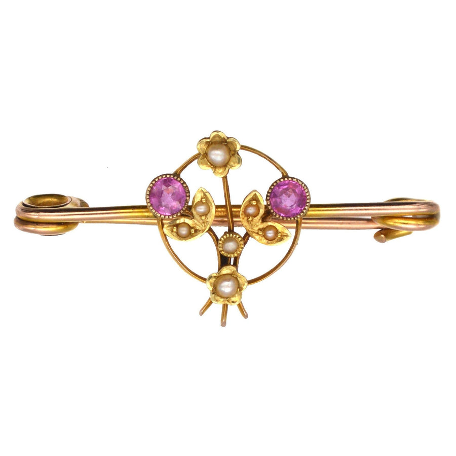 Edwardian 9ct gold brooch featuring pink sapphires and natural split pearls, styled as a flower basket from 1912.