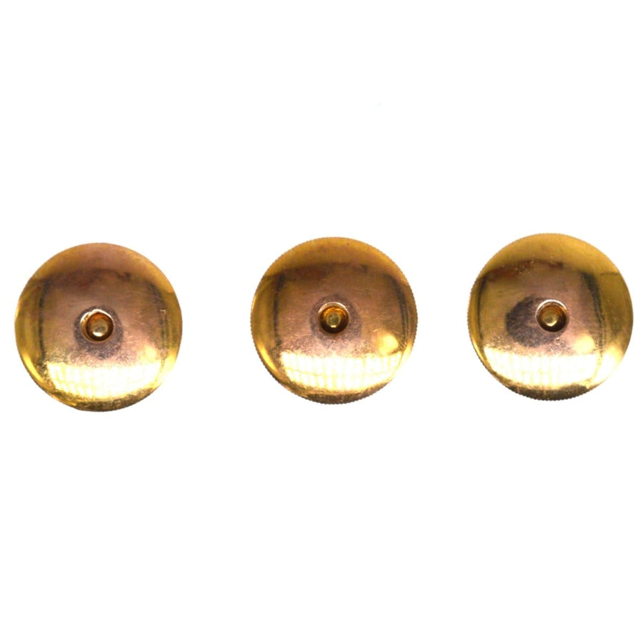 Elegant Edwardian 9ct gold and platinum dress studs with mother of pearl and ruby details, set of three.
