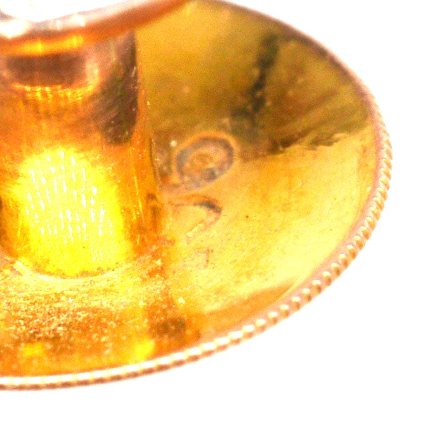 Close-up of the hallmark and detailed view of a 9ct gold dress stud, showcasing craftsmanship and quality.