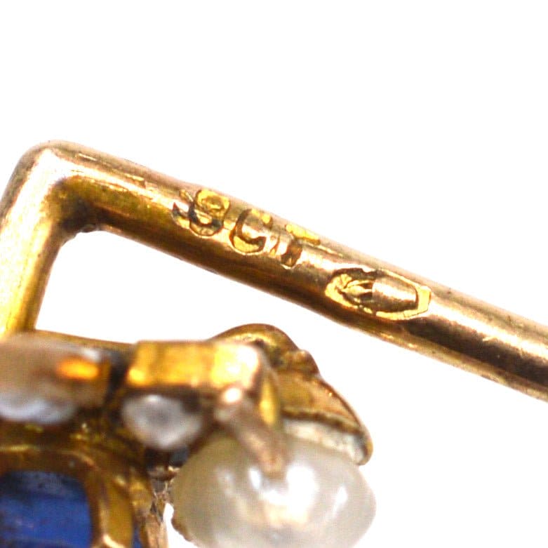 Close-up of a hallmark on an Edwardian 9ct gold sapphire and natural pearl bee tie pin.